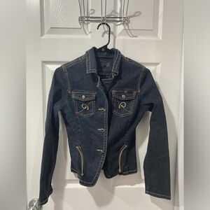 Rocawear women’s jean jacket, dark blue with designs, size S, good condition.